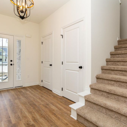 Hardwood floors in a hallway by Luxx Flooring