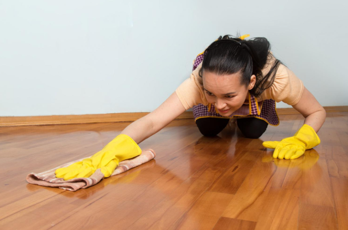 Woman washing hardwood flooring