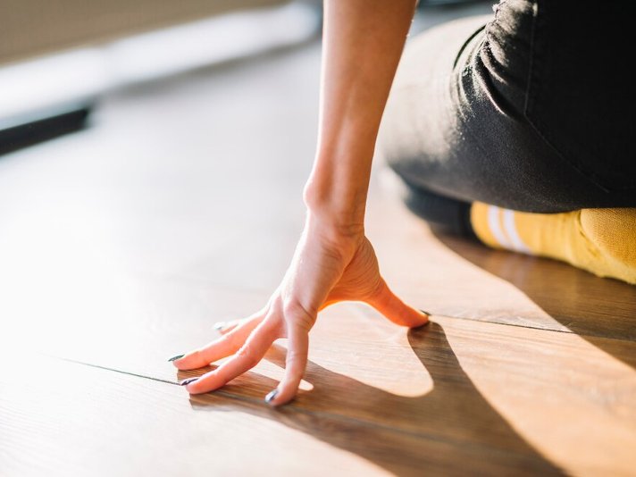 Hand on a hardwood floor